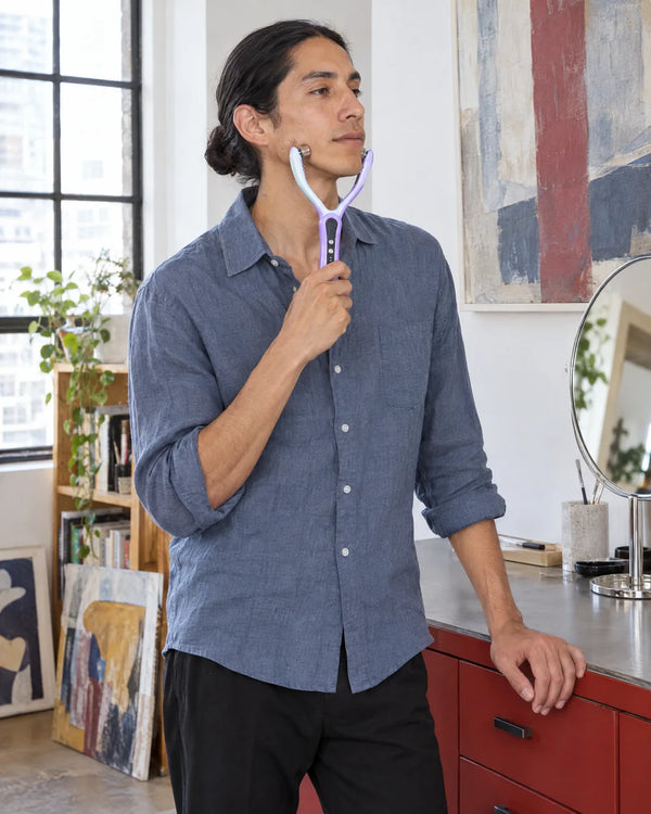 AI-created lifestyle illustration of an adult using the Purple facial roller.