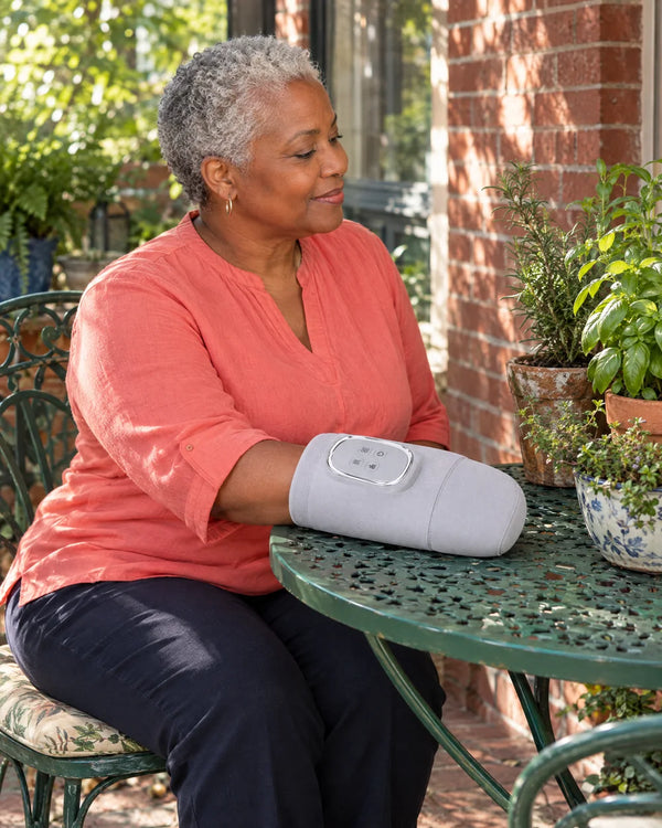 AI-created lifestyle illustration of an adult using the Light Gray hand massager.